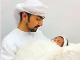  ?? WAM ?? Dr Abdullah Al Amiri with his daughter Zeina who was born in Kuwait this April.