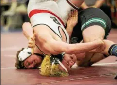  ?? NATE HECKENBERG­ER — FOR DIGITAL FIRST MEDIA ?? Boyertown’s Jacob Miller tries to roll away from Pennridge’s Josh Stillings before getting pinned in the 182-pound final.