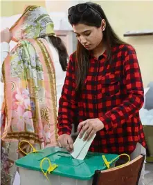  ??  ?? One for me: A woman casting her ballot during the by-election in Lahore. — AFP