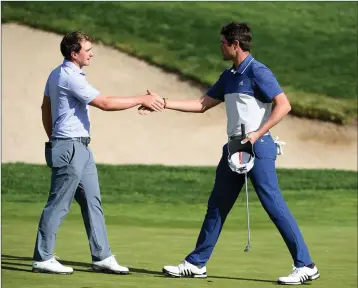  ??  ?? Wicklow’s Paul Dunne and Nacho Elvira of Spain on the 18th green during the third round of the Open de Espana at Centro Nacional de Golf on April 14 in Madrid, Spain.