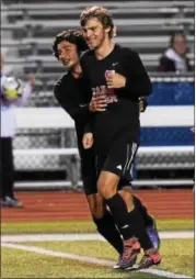  ?? AUSTIN HERTZOG - DIGITAL FIRST MEDIA ?? Boyertown’s Alex Kidwell, center, is congratula­ted by Nik Verma after scoring a goal against Spring-Ford on Oct. 11.