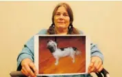  ?? JEAN LEVAC/OTTAWA CITIZEN ?? Jessica Johnson, 64, holds a photo of her dog Vicki. Johnson was charged by the OSPCA with failing to care for her dog.