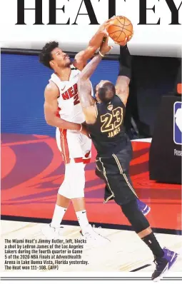  ??  ?? The Miami Heat’s Jimmy Butler, left, blocks a shot by LeBron James of the Los Angeles Lakers during the fourth quarter in Game
5 of the 2020 NBA Finals at AdventHeal­th Arena in Lake Buena Vista, Florida yesterday. The Heat won 111-108. (AFP)