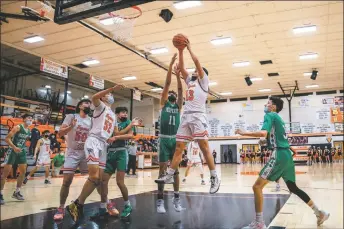  ?? ?? The Tigers Isiah Jeantete rebounds during a home game against the Moriarty Pintos on Monday (Jan. 31).