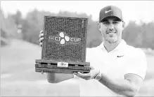 ?? PARK JI-HO THE ASSOCIATED PRESS ?? Brooks Koepka of the United States poses with his trophy after winning the CJ Cup at Nine Bridges golf course in Korea on Sunday.