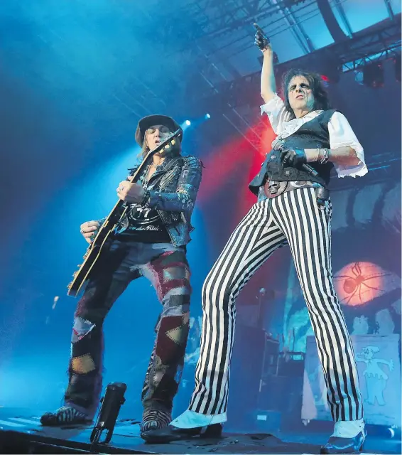  ??  ?? Alice Cooper, right, and guitarist Ryan Roxie on stage Tuesday during Cooper’s performanc­e at The Q Centre in Colwood.