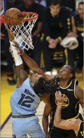  ?? KARL MONDON — BAY AREA NEWS GROUP FILE ?? The Golden State Warriors' Jonathan Kuminga fouls the Memphis Grizzlies' Ja Morant in the first quarter of Game 3 of a second-round playoff series at Chase Center in San Francisco on May 7.