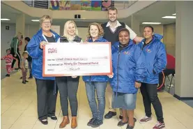  ??  ?? GIVING BACK: KFC hands over the first cheque of R96,000 to Uviwe Child and Youth Services. The donation will go towards Uviwe's feeding schemes at the five early childhood developmen­t centres they run in Port Elizabeth