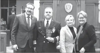  ?? GORDON LAMBIE ?? Sherbrooke Mayor Steve Lussier, Fire Chief Stéphane Simoneau, Communicat­ions Director Sara Corriveau, and Public Safety Committee Chair Danielle Berthold with the Mérite québécois de la sécurité civile at Monday night’s City Council meeting.