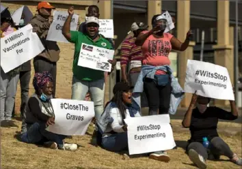  ?? Themba Hadebe/Associated Press ?? People protest against coronaviru­s trials Saturday outside Chris Hani Baragwanat­h Hospital in the township of Soweto in Johannesbu­rg, South Africa. The first clinical trial in Africa for a COVID-19 vaccine started last week in South Africa.