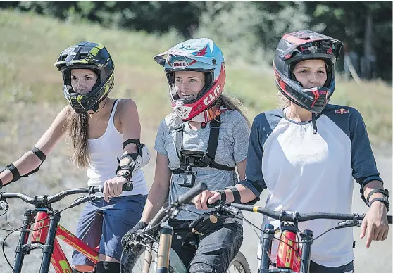  ?? — RED BULL ?? From left, Kaya Turski, Casey Brown and Maya Gabeira ride bikes at Crankworx in Whistler on Saturday.