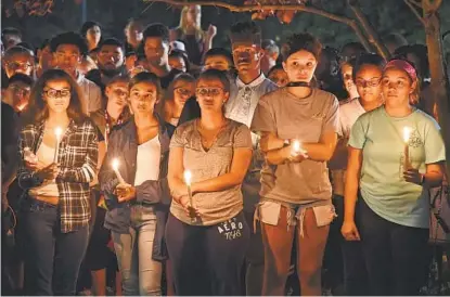  ?? AMY DAVIS/BALTIMORE SUN ?? Several hundred people attended a candleligh­t vigil at Murray Hill Middle School Thursday night for Wilde Lake High School teacher Laura Wallen, whose body was found Wednesday in a Damascus field. Wallen previously taught at the middle school.