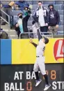  ?? Frank Franklin II / Associated Press ?? A fan catches a ball hit by Tampa Bay Rays’ Francisco Mejia for a home run as New York Yankees right fielder Aaron Judge leaps at the wall during the second inning on Saturday.