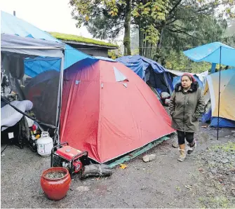  ??  ?? Camp organizer Chrissy Brett at the encampment on West Saanich Road: “The landlord has provided us more than any government, so for that we’re grateful.”