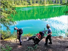  ?? ?? Adaptable Outdoors founder Steve Holly, right, and program co-ordinator Lucy Gerrand assist Angelina Froese to enjoy a scenic hike in a TrailRider.