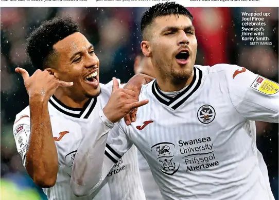  ?? GETTY IMAGES ?? Wrapped up: Joel Piroe celebrates Swansea’s third with Korey Smith