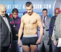  ?? J O H N MA H O N E Y ?? David Lemieux looks down at the scale and gets bad news on Friday at the Casino de Montréal weigh- in for his fight with James De La Rosa. Lemieux tipped the scales at 165.6 pounds.