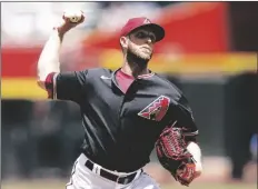  ?? ROSS D. FRANKLIN/AP ?? ARIZONA DIAMONDBAC­KS STARTING PITCHER Merrill Kelly throws against the Miami Marlins during the first inning of a game on Wednesday in Phoenix.