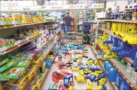  ?? Irfan Khan Los Angeles Times ?? JAVAID WASEEM, owner of a gas station and store in Ridgecrest, Calif., surveys the damage after the magnitude 6.4 quake Thursday.