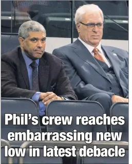  ?? Anthony J. Causi ?? TROUBLED TIMES: Knicks general manager Steve Mills (left) and president Phil Jackson look on during a 110-96 loss to the Pelicans on Monday, a game for which Derrick Rose did not show and in which Carmelo Anthony and Kyle O’Quinn were ejected.