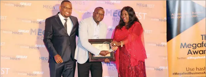  ??  ?? Alpha Media Holdings chief operations officer Kangai Maukazuva (centre) receives his Strategic Leadership Award from Apostle Florence Kanyati (right), while Megafest chief executive Tafadzwa Matsika looks on at the Megafest 2018 awards ceremony at the Harare Internatio­nal Conference Centre