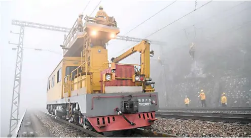  ??  ?? WORKERS conduct safety check during an overhaul of the overhead line system at a section of the Nanning-Kunming railway in Baise City, south China’s Guangxi Zhuang Autonomous Region.