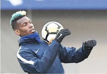  ?? — AFP photo ?? France's midfielder Paul Pogba controls the ball during a training session in Clairefont­aine-en-Yvelines, southwest of Paris, on March 19, 2018, as part of the team's preparatio­n for the friendly football matches against Colombia and Russia.