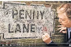  ??  ?? Paul McCartney signiert das Straßensch­ild an der Penny Lane.