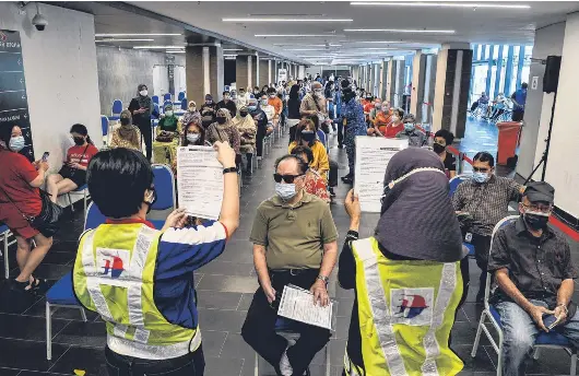 Malaysia's Covid-19 assessment centres see surge in ...