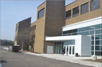  ?? ANNE RUNKLE — MEDIANEWS GROUP ?? A crew member enters The Hawk, the new recreation and performing arts center housed in the former Harrison High School in Farmington Hills. Workers are putting the finishing touches on the facility, which is tentativel­y scheduled to open June 1.