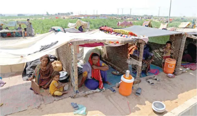  ?? Agencefran­ce-presse ?? Internally displaced people take shelter in their makeshift tents in Hyderabad, Sindh province, on Sunday.