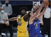  ?? DAVID ZALUBOWSKI — THE ASSOCIATED PRESS ?? Denver Nuggets center Nikola Jokic, front, drives to the rim for a reverse dunk basket past Warriors center James Wiseman in the first half on Thursday.