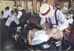  ?? Travis Haight ?? MANLY & SONS
features classic chairs and barbers in retro-cool attire.