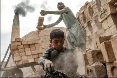  ?? ?? An 8-year-old Afghan boy works July 23 at a brick factory on the outskirts of Kabul.