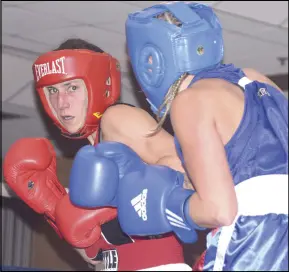  ??  ?? Danielle Fife, in red, withers under a hail of blows from Beyond Boxing’s Destiny Wysote at Friday night’s bouts. Wysote went on to win the match.