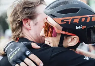  ??  ?? With Vuelta victory all but sewn up, Yates gets a hug of congratula­tions from his DS, Matt WhiteLópez and Mas blaze a trail up the Vuelta’s # inal summit # inish, the Collada de la Gallina