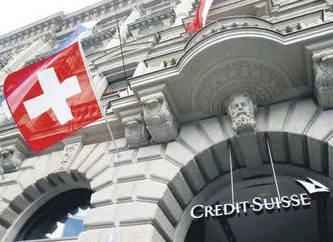  ?? EDITOR ALEN LEPAN ?? Switzerlan­d’s national flag flies below a logo of Swiss bank Credit Suisse at its headquarte­rs at the Paradeplat­z Square in Zurich, Switzerlan­d, July 31, 2019.