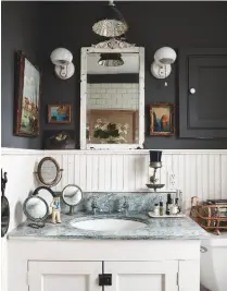  ??  ?? BATHROOM
Slimline wainscot panelling and dark grey walls are a smart combinatio­n. The green-hued marble used on the vanity unit came from an old hotel. Walls in Kendall Charcoal, Benjamin Moore. Similar marble-top vanity unit, Catchpole & Rye