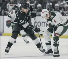  ?? Ashley Landis Associated Press ?? KINGS CENTER Gabriel Vilardi, left, tries to pass around Wild defenseman Jon Merrill in the second period. Los Angeles won its third in a row at home.