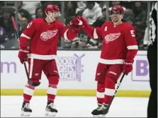  ?? ASHLEY LANDIS — THE ASSOCIATED PRESS ?? Detroit Red Wings left wing Dominik Kubalik (81) celebrates with left wing David Perron (57) after scoring during the first period of an NHL hockey game against the Los Angeles Kings Saturday in Los Angeles.