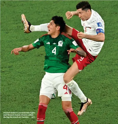  ?? — afp ?? Poland’s Robert Lewandowsk­i (right) and Mexico’s Edson Alvarez collide during the match on Tuesday.