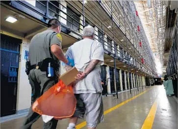 ?? Gary Coronado Los Angeles Times ?? A DEATH ROW inmate is escorted to his cell at San Quentin State Prison last year. Legal experts say it’s possible that Gov. Jerry Brown and defense lawyers could delay executions until he leaves office in 2019.