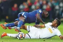  ?? AP ?? Chelsea’s Antonio Rudiger and Swansea City’s Jordan Ayew (right) battle hard during a Premier League match at the Liberty Stadium on Saturday.