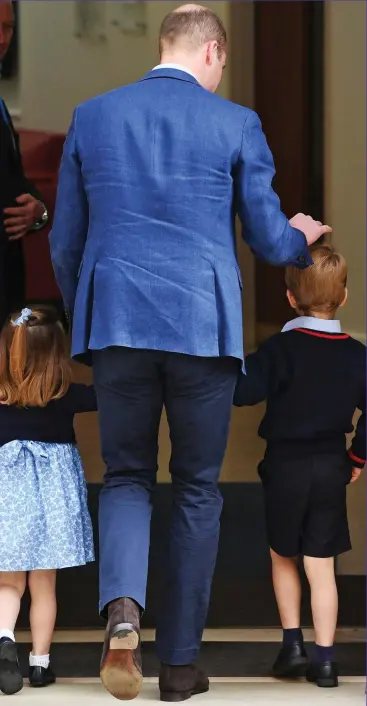  ??  ?? In we go: William takes his children inside, laying a reassuring hand on George’s head