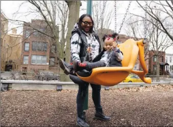  ?? (AP/Erin Hooley) ?? Chicago educator Tamisha Holifield plays with her 2-year-old daughter Rian Holifield Dec. 29 at Nichols Park in the Hyde Park neighborho­od of Chicago. When Holifield and her daughter have experience­d bouts of colds and covid-19 in what Holifield described as a “constant whirlwind” of sickness, it has been stressful both financiall­y and emotionall­y.