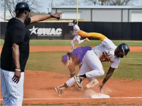  ?? (Pine Bluff Commercial/I.C. Murrell) ?? Brandon Simon of UAPB slides into third base and takes off for home plate as directed by Coach Carlos James after a passed ball by Alcorn State in the second inning Friday at Bill Jones Field at the Torii Hunter Complex. At third base is Nathan Gamez of Alcorn State.