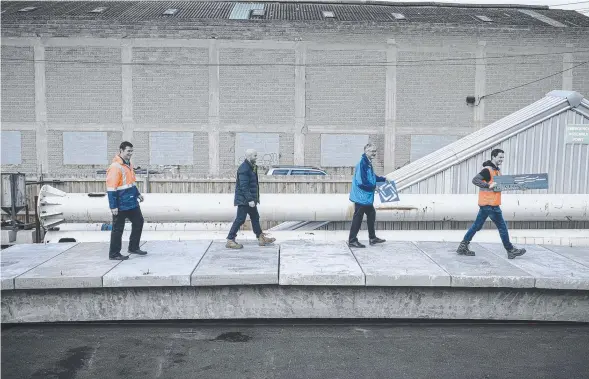  ??  ?? FUTURE DIRECTION: The City of Greater Geelong's Chris Marston (left) and Aaron McGlade (right) flank Austeng engineer Luke Smith and managing director Ross George as they ham it up on the bridge designed to last 100 years without maintenanc­e.