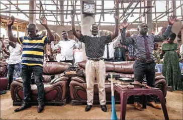  ?? AFP ?? Congregant­s of the Primitive Church of the Lord pray during the Sunday service in Bukavu, eastern Democratic Republic of Congo, on March 20.