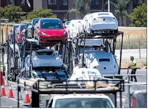  ?? Bloomberg file photo ?? Tesla Inc. vehicles are loaded onto a carrier truck for transport at the company’s factory in Fremont, Calif.