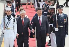  ?? JOE RAEDLE, GETTY IMAGES ?? Secretary of State Rex Tillerson walks with Chinese President Xi Jinping upon arrival in West Palm Beach, Fla.